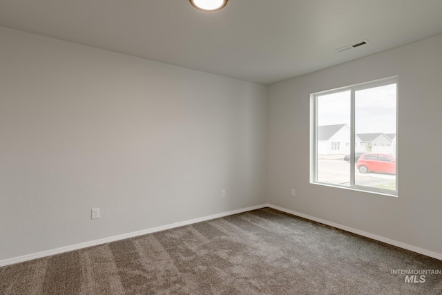 unfurnished room featuring carpet