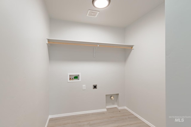 laundry room featuring washer hookup, light hardwood / wood-style floors, and hookup for an electric dryer