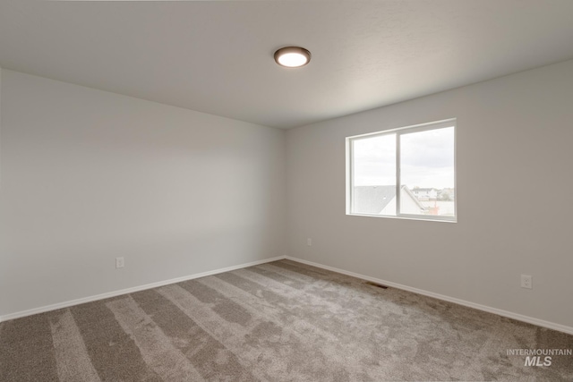 empty room with light colored carpet