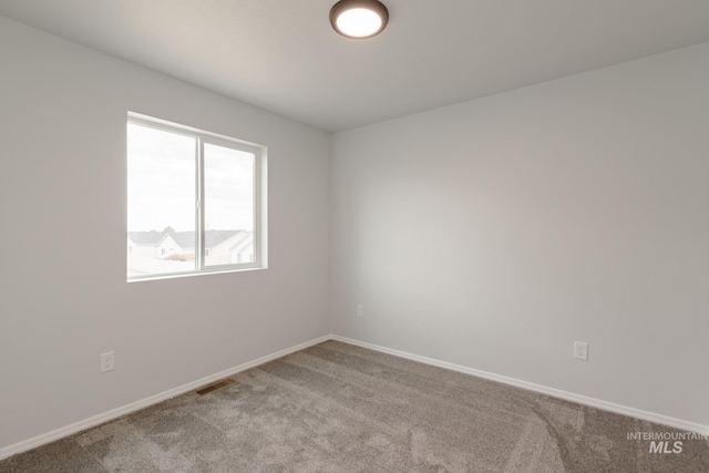 spare room with light colored carpet