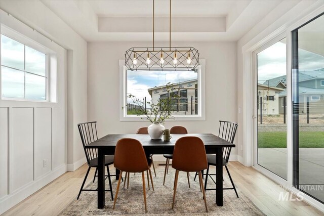 7680 W Old School St, Meridian, ID 83646 - dining room featuring a raised ceiling, light wood-type flooring, and baseboards
