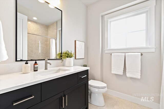 7680 W Old School St, Meridian, ID 83646 - full bathroom featuring vanity, tile patterned flooring, baseboards, toilet, and a shower with curtain