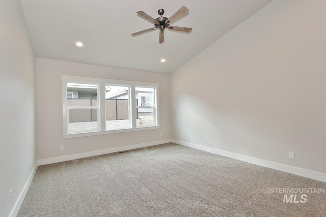 carpeted spare room with lofted ceiling, recessed lighting, and baseboards