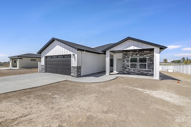 1012 23rd Ave E, Jerome, ID 83338 - modern inspired farmhouse with stone siding, an attached garage, board and batten siding, and concrete driveway