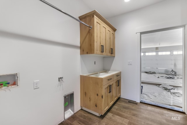 1012 23rd Ave E, Jerome, ID 83338 - washroom with cabinet space, dark wood-style flooring, and hookup for a washing machine