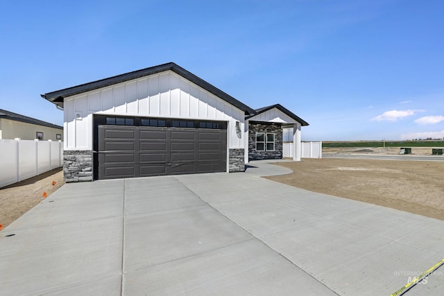 1012 23rd Ave E, Jerome, ID 83338 - modern farmhouse style home with stone siding, board and batten siding, driveway, and a garage