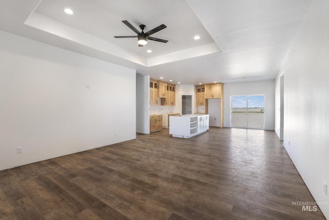 1012 23rd Ave E, Jerome, ID 83338 - unfurnished living room featuring a tray ceiling, ceiling fan, dark wood-style flooring, and recessed lighting