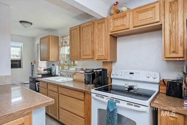 722 Nevada St, Gooding, ID 83330 - kitchen with white electric range oven, a sink, and light countertops