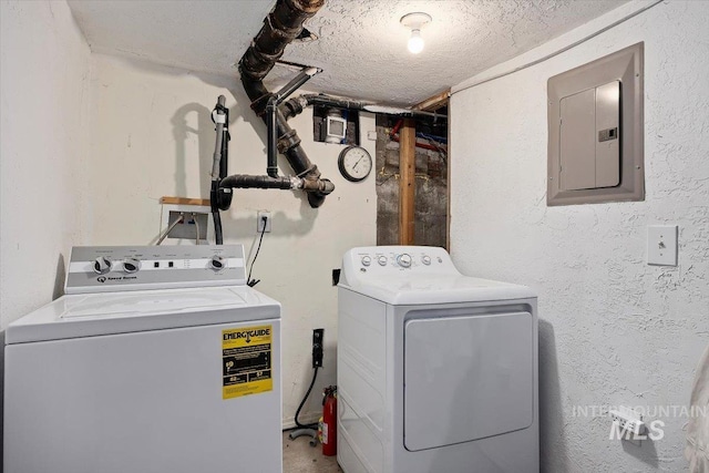 722 Nevada St, Gooding, ID 83330 - laundry room with washing machine and dryer, electric panel, and a textured wall