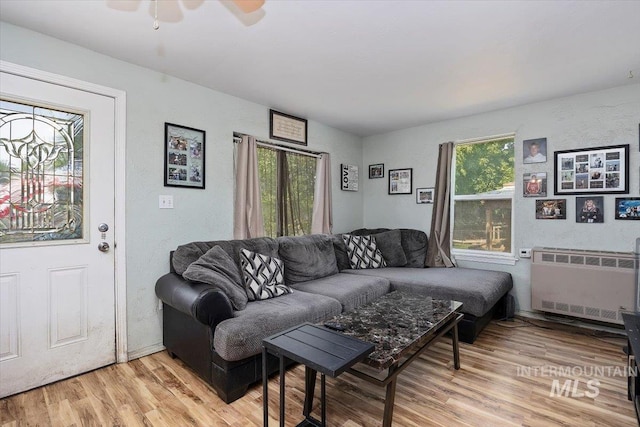 722 Nevada St, Gooding, ID 83330 - living area with radiator, plenty of natural light, and light wood-style floors
