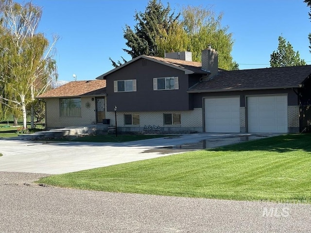 split level home with a garage and a front yard