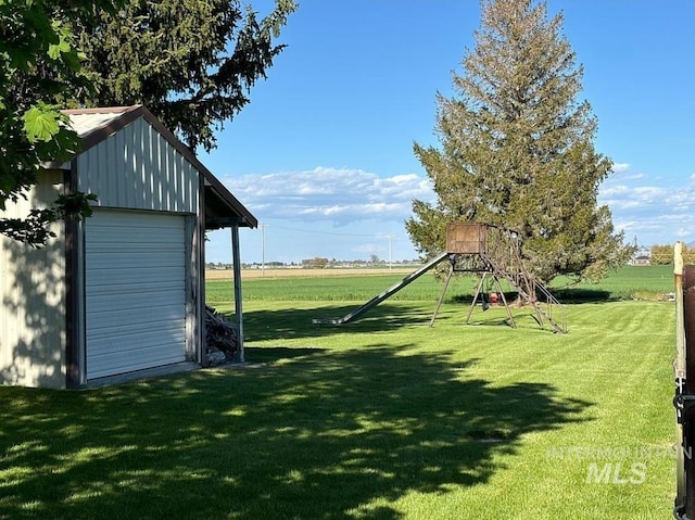 view of yard with an outdoor structure and a playground