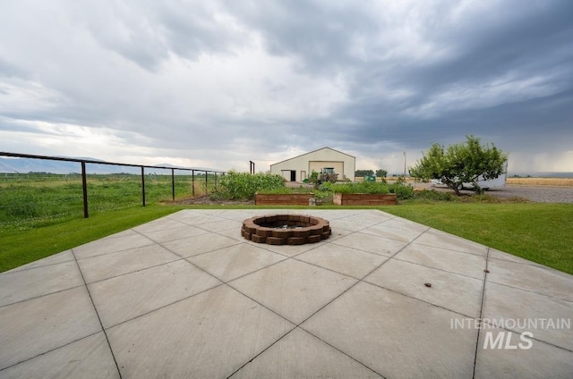 view of patio / terrace featuring a fire pit and fence