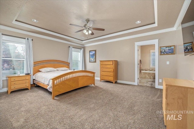 carpeted bedroom featuring baseboards, ornamental molding, a tray ceiling, and recessed lighting