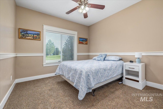 carpeted bedroom featuring baseboards and a ceiling fan