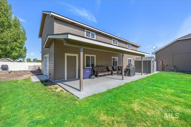 rear view of property with fence, a storage shed, an outbuilding, a patio, and a yard