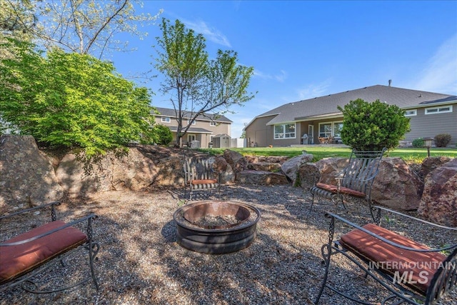 view of yard featuring an outdoor fire pit