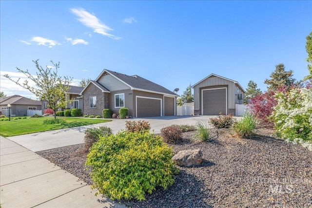 ranch-style home with concrete driveway, an attached garage, stone siding, and a front lawn