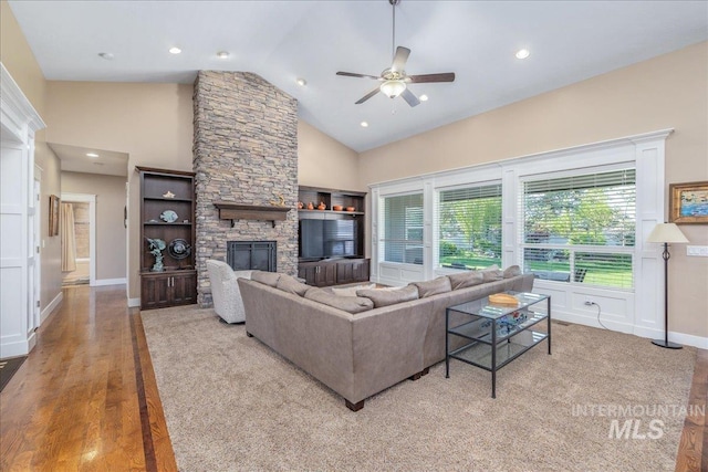 living area featuring ceiling fan, a fireplace, recessed lighting, baseboards, and wood finished floors
