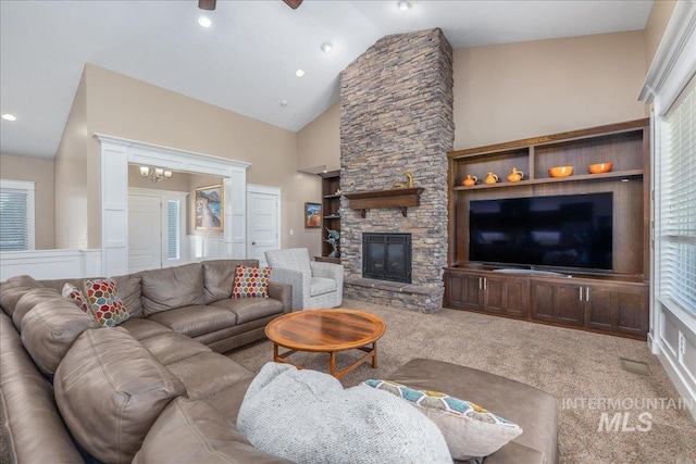 carpeted living area featuring recessed lighting, high vaulted ceiling, and a stone fireplace