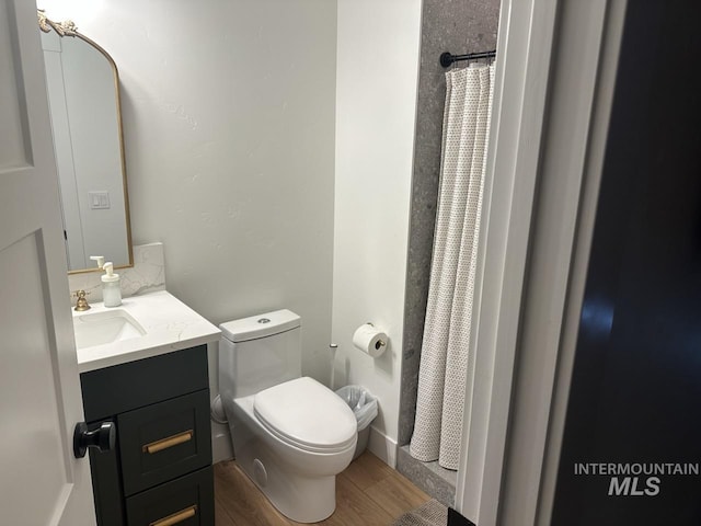 1047 Kaitlyn Loop, Mccall, ID 83638 - bathroom with vanity, toilet, wood finished floors, and curtained shower