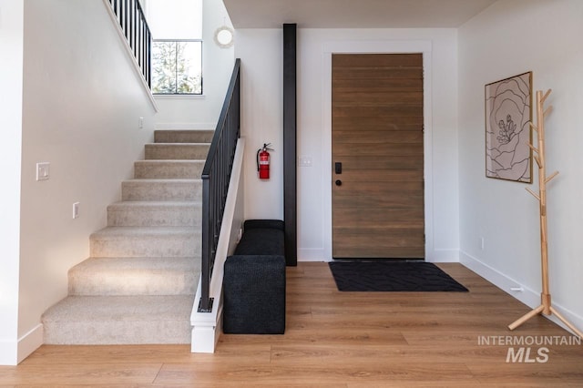 1047 Kaitlyn Loop, Mccall, ID 83638 - foyer entrance with stairway, wood finished floors, and baseboards