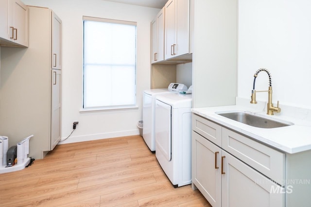 1047 Kaitlyn Loop, Mccall, ID 83638 - laundry room featuring washer and dryer, cabinet space, light wood-style flooring, and healthy amount of natural light