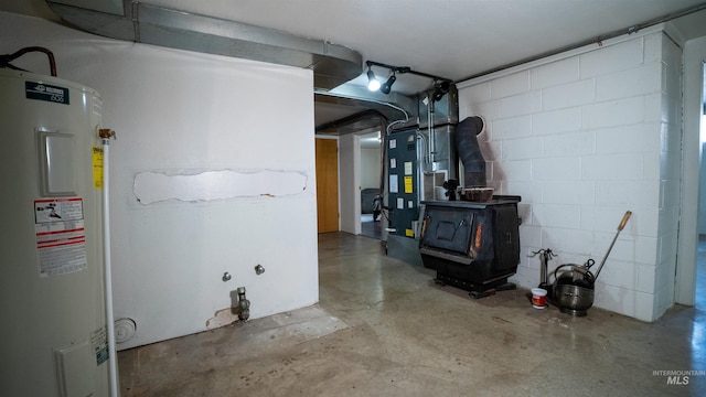 utility room featuring heating unit and water heater