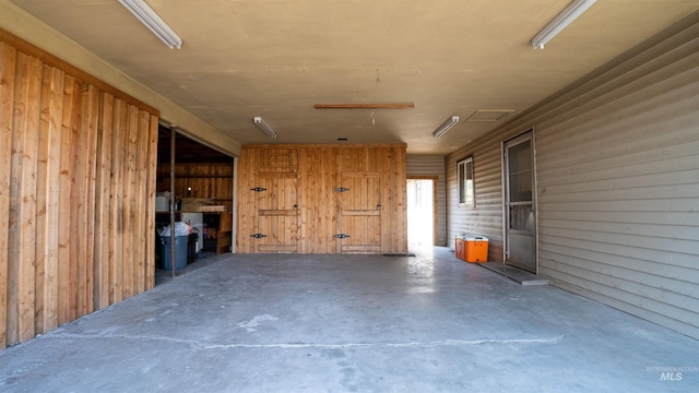 interior space featuring wooden walls