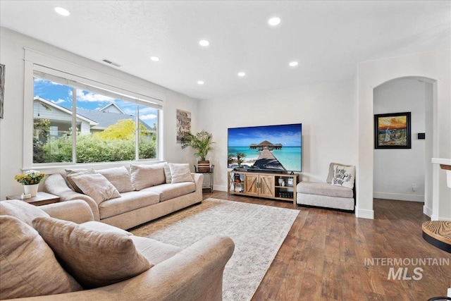 1041 White Horse Ridge Dr, Middleton, ID 83644 - living area with recessed lighting, dark wood-style flooring, baseboards, and arched walkways