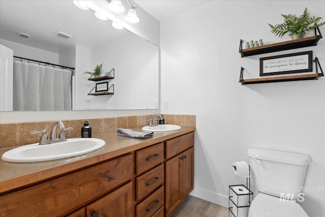 1041 White Horse Ridge Dr, Middleton, ID 83644 - full bath with double vanity, toilet, baseboards, and wood finished floors