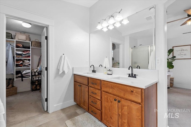 1041 White Horse Ridge Dr, Middleton, ID 83644 - bathroom with double vanity, a stall shower, a walk in closet, and baseboards
