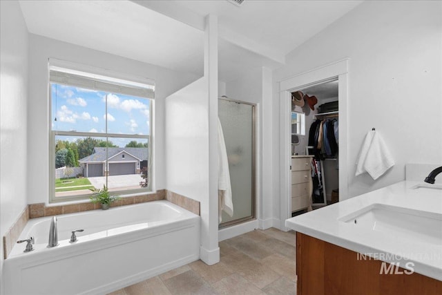 1041 White Horse Ridge Dr, Middleton, ID 83644 - full bath featuring a stall shower, a bath, a spacious closet, and double vanity