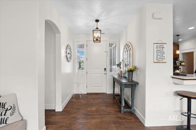 1041 White Horse Ridge Dr, Middleton, ID 83644 - foyer featuring baseboards, wood finished floors, arched walkways, and recessed lighting