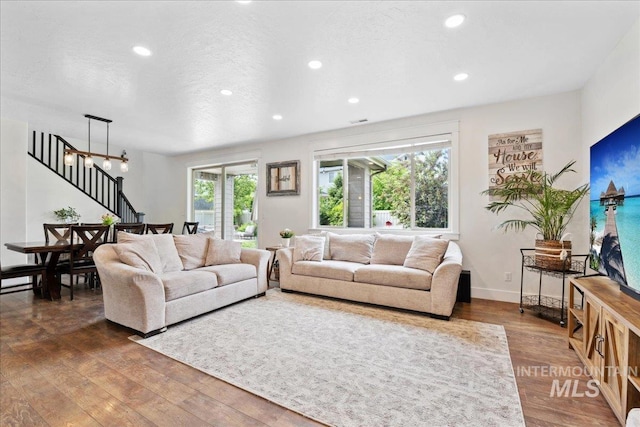 1041 White Horse Ridge Dr, Middleton, ID 83644 - living room with recessed lighting, wood finished floors, stairs, a chandelier, and baseboards