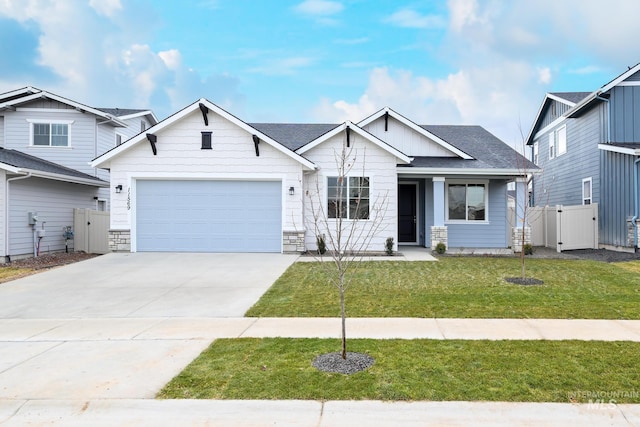 view of front of property featuring a garage and a front lawn