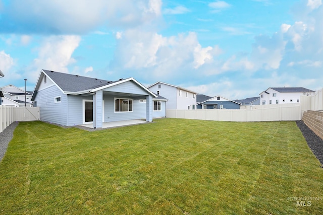 back of property featuring a yard and a patio