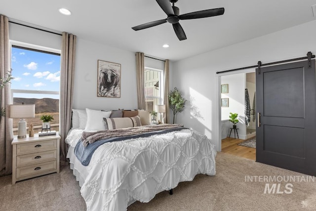 5251 Hidden Hollow Ln, Emmett, ID 83617 - bedroom featuring a barn door, recessed lighting, light colored carpet, and a ceiling fan