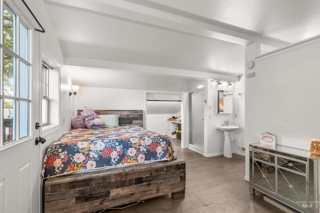 bedroom featuring ensuite bathroom and sink