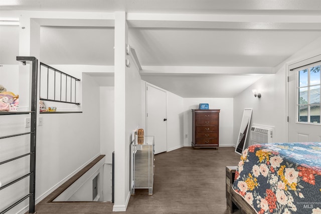 bedroom with a wall mounted AC and dark hardwood / wood-style floors