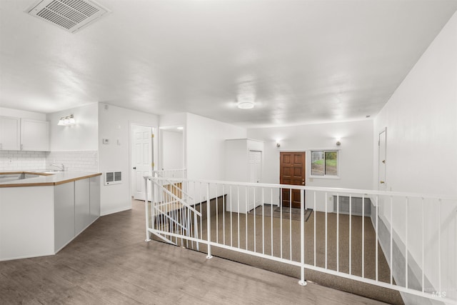 hallway featuring light wood-type flooring and sink