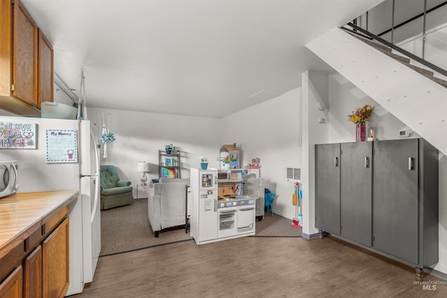 kitchen featuring hardwood / wood-style floors and white appliances