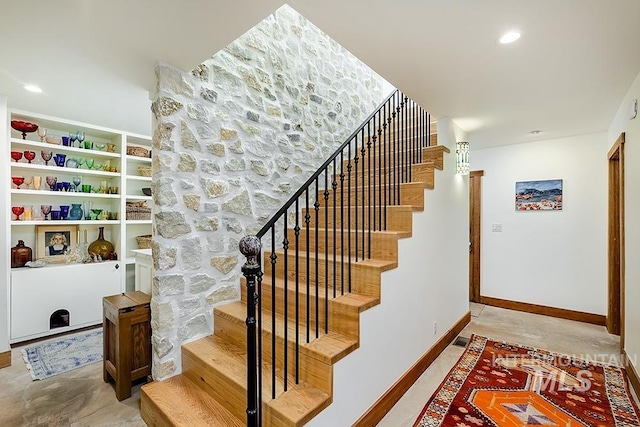 stairway with recessed lighting and baseboards