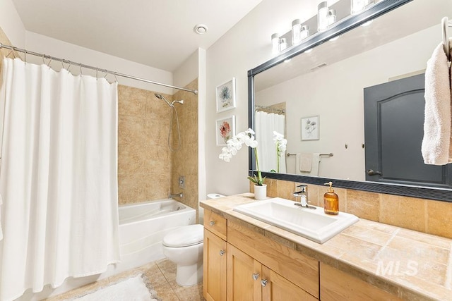 bathroom with tasteful backsplash, vanity, tile patterned flooring, toilet, and shower / bath combo with shower curtain
