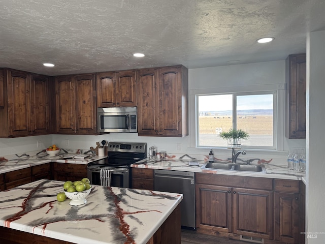 kitchen featuring a sink, light countertops, and stainless steel appliances