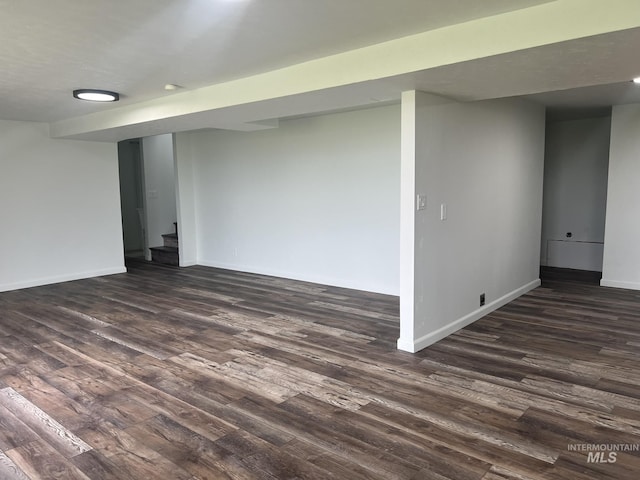 interior space featuring stairs, baseboards, and dark wood finished floors