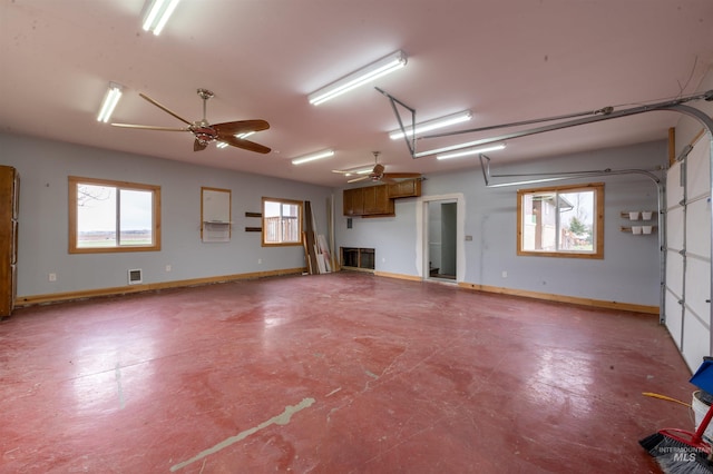 garage featuring visible vents, baseboards, and ceiling fan