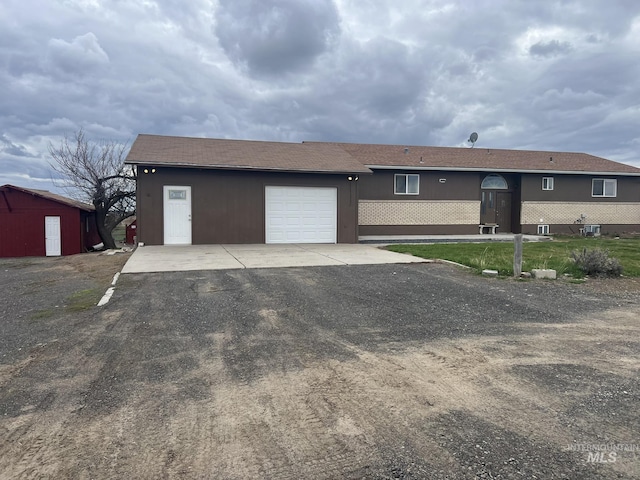 single story home with driveway and a garage