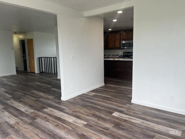 interior space with recessed lighting, dark wood-style floors, and baseboards