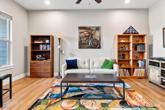 living room featuring plenty of natural light, a ceiling fan, and wood finished floors